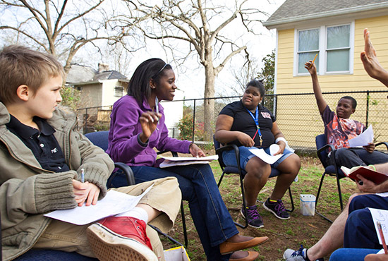 woman leads group of youth in discussion