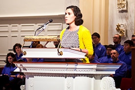 young woman preaching at lecturn